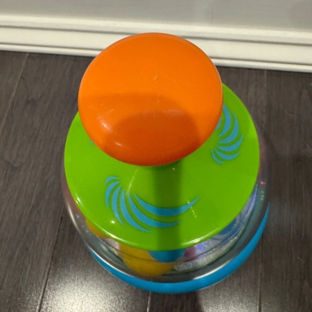 Orange and Green Press and Spin Learning Baby Toy